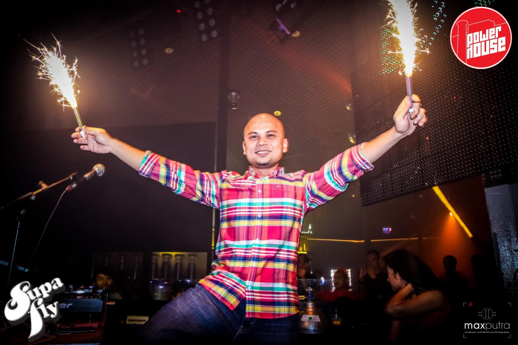 DJ Kzee celebrating on stage with sparklers