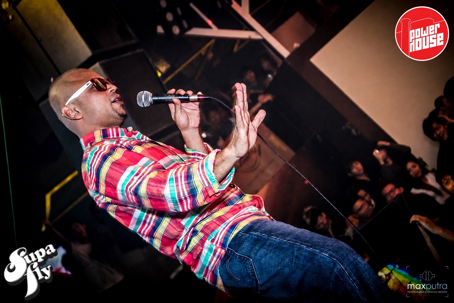 DJ Kzee performing live with a microphone at Powerhouse